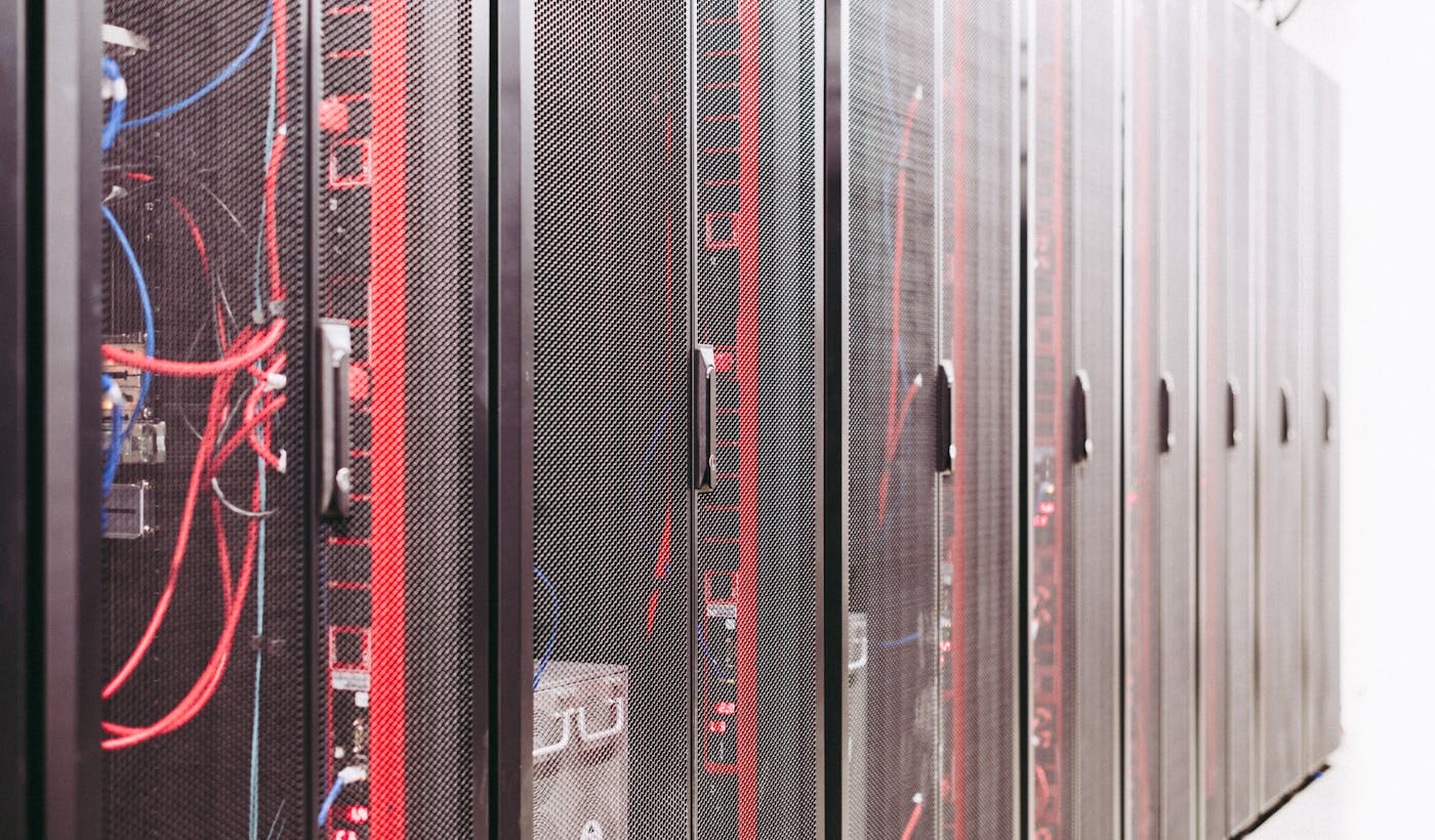 Server racks in a data center representing hosting resources