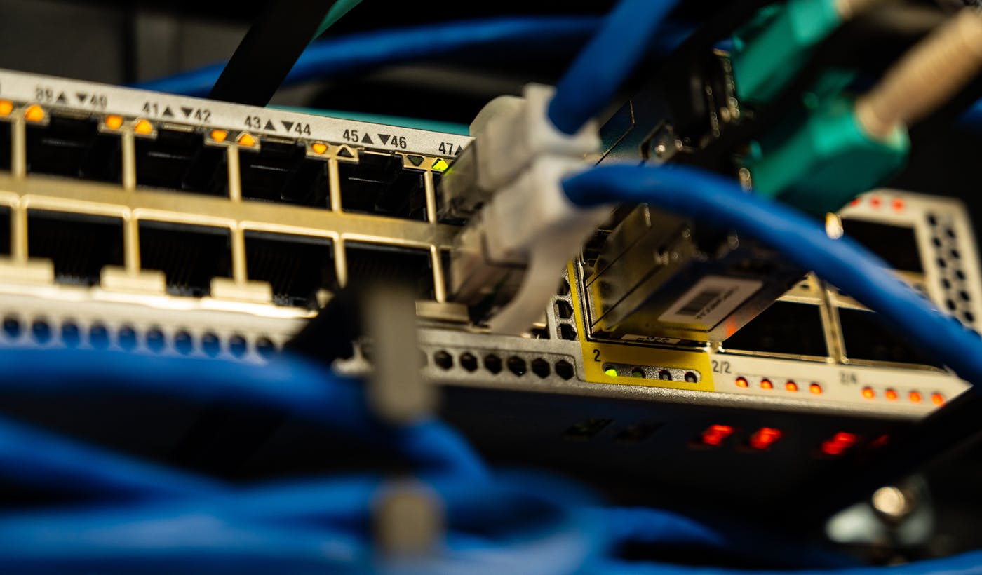 Ethernet cables plugged into a network switch representing DNS and nameservers